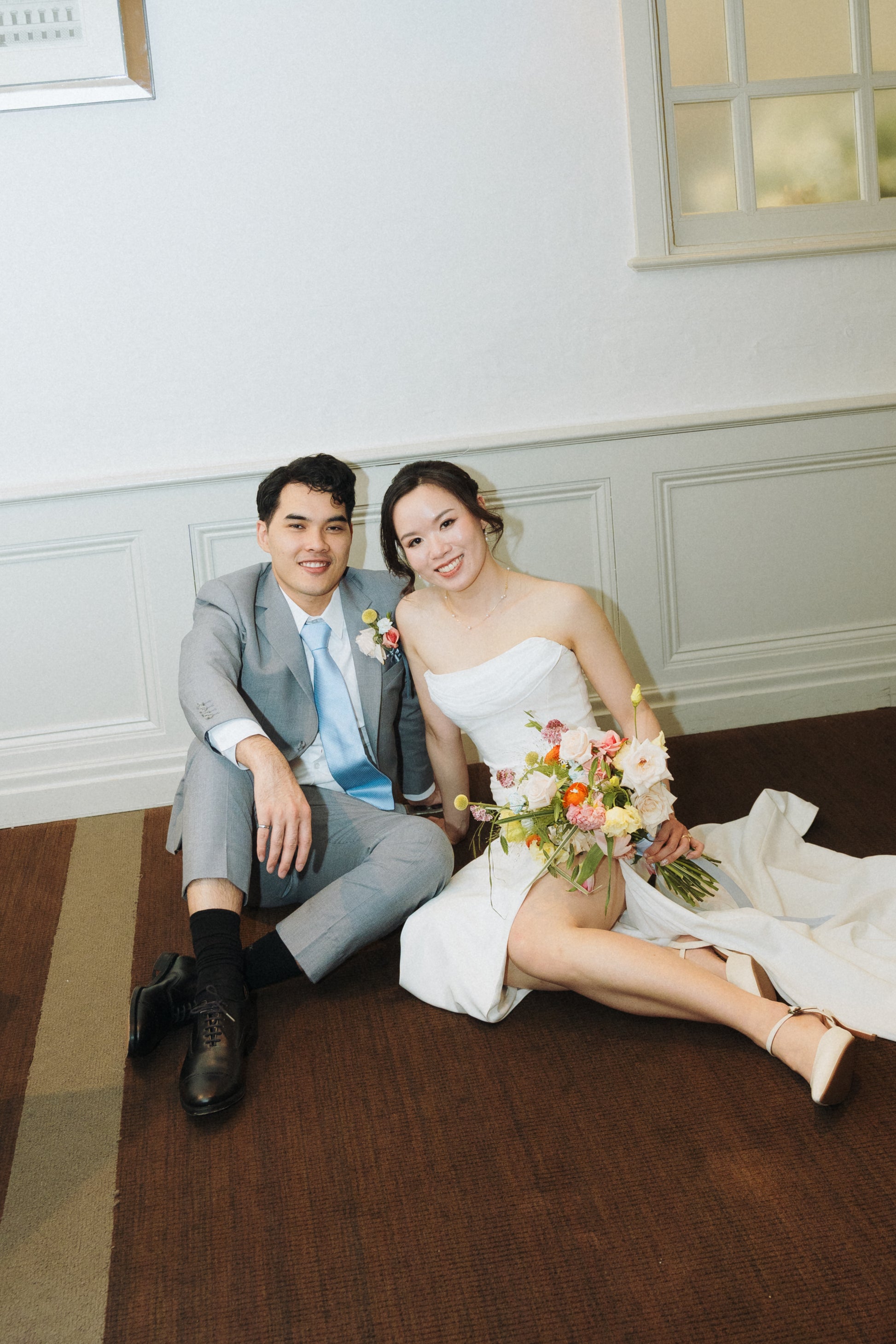Bride Anna in custom wedding gown with groom in matching bespoke suit