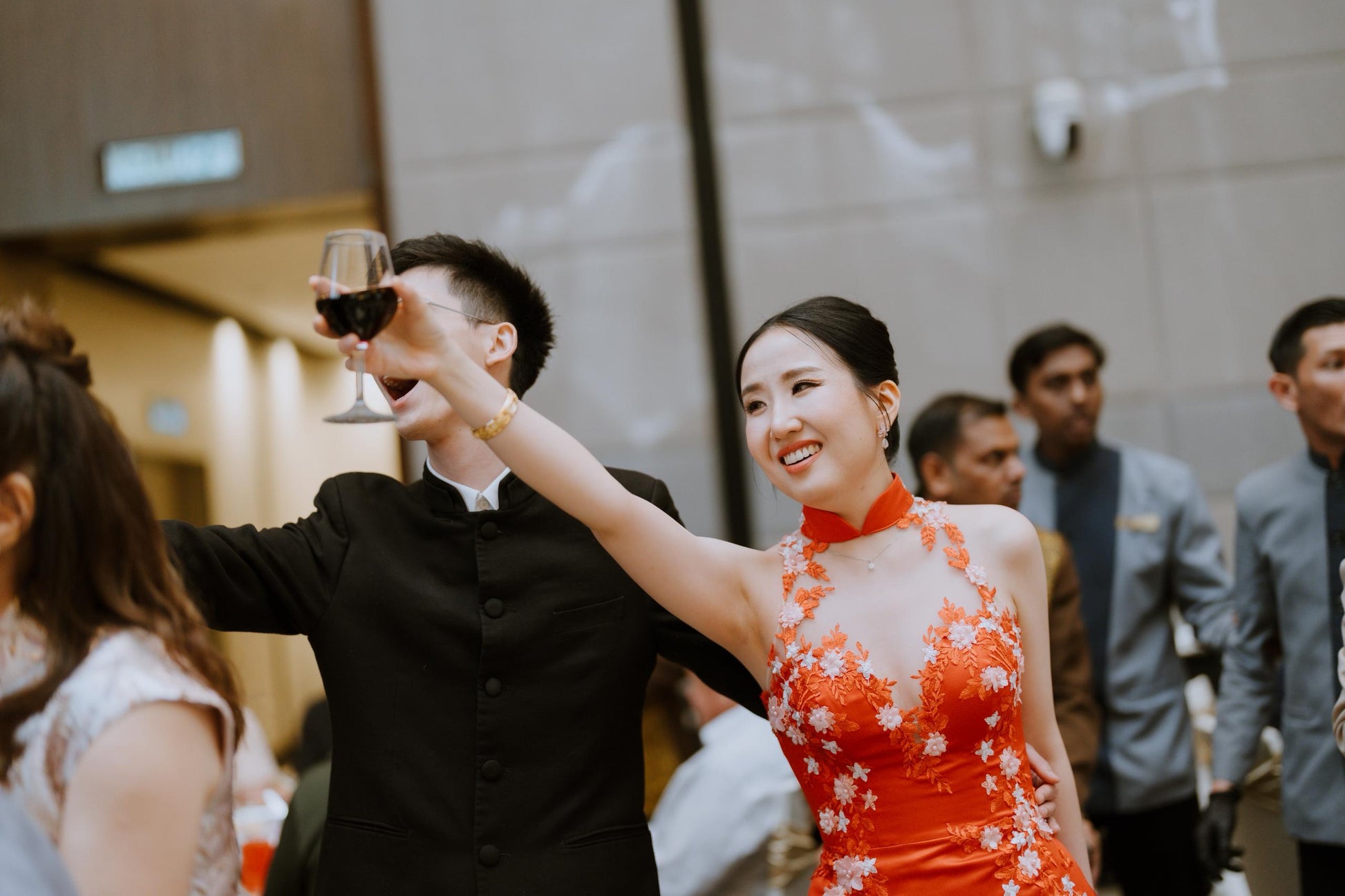 Red cheongsam-inspired bridal gown with intricate detailing