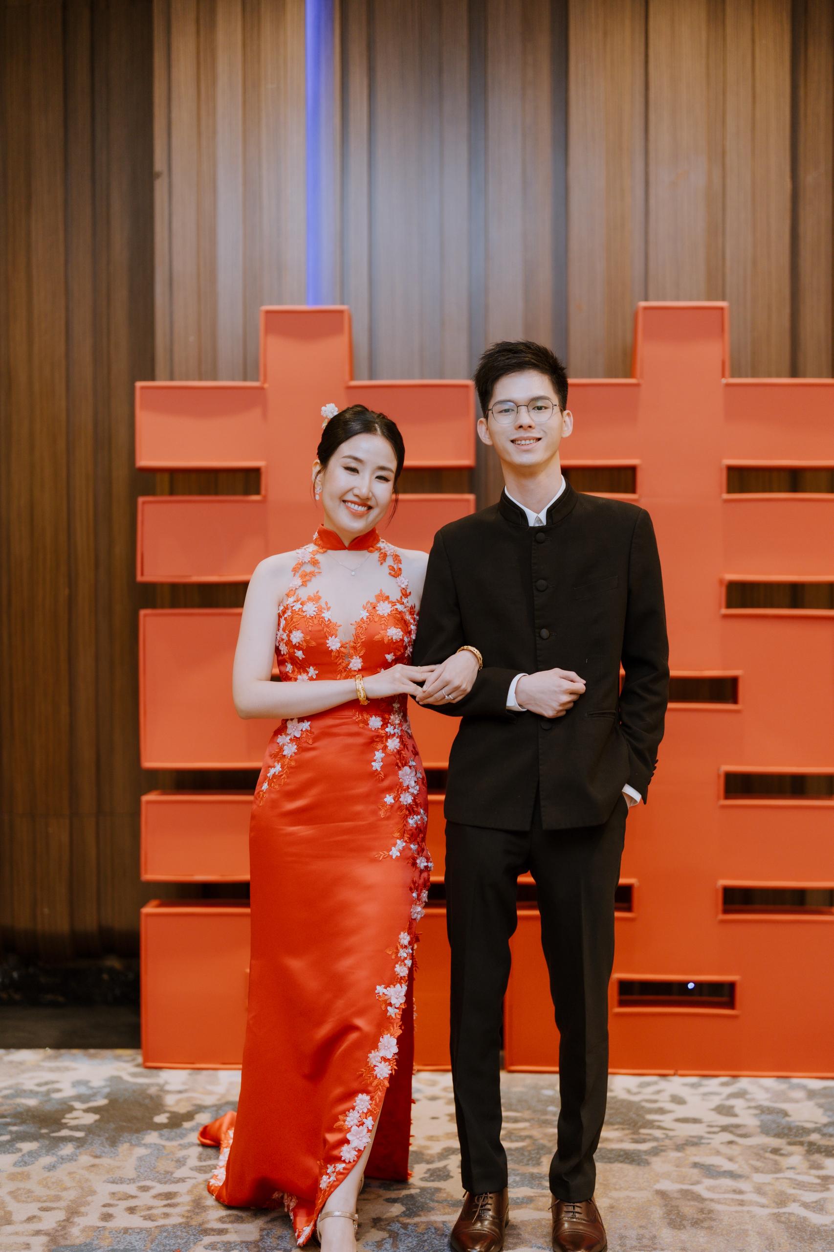 Red cheongsam-inspired bridal gown with intricate detailing