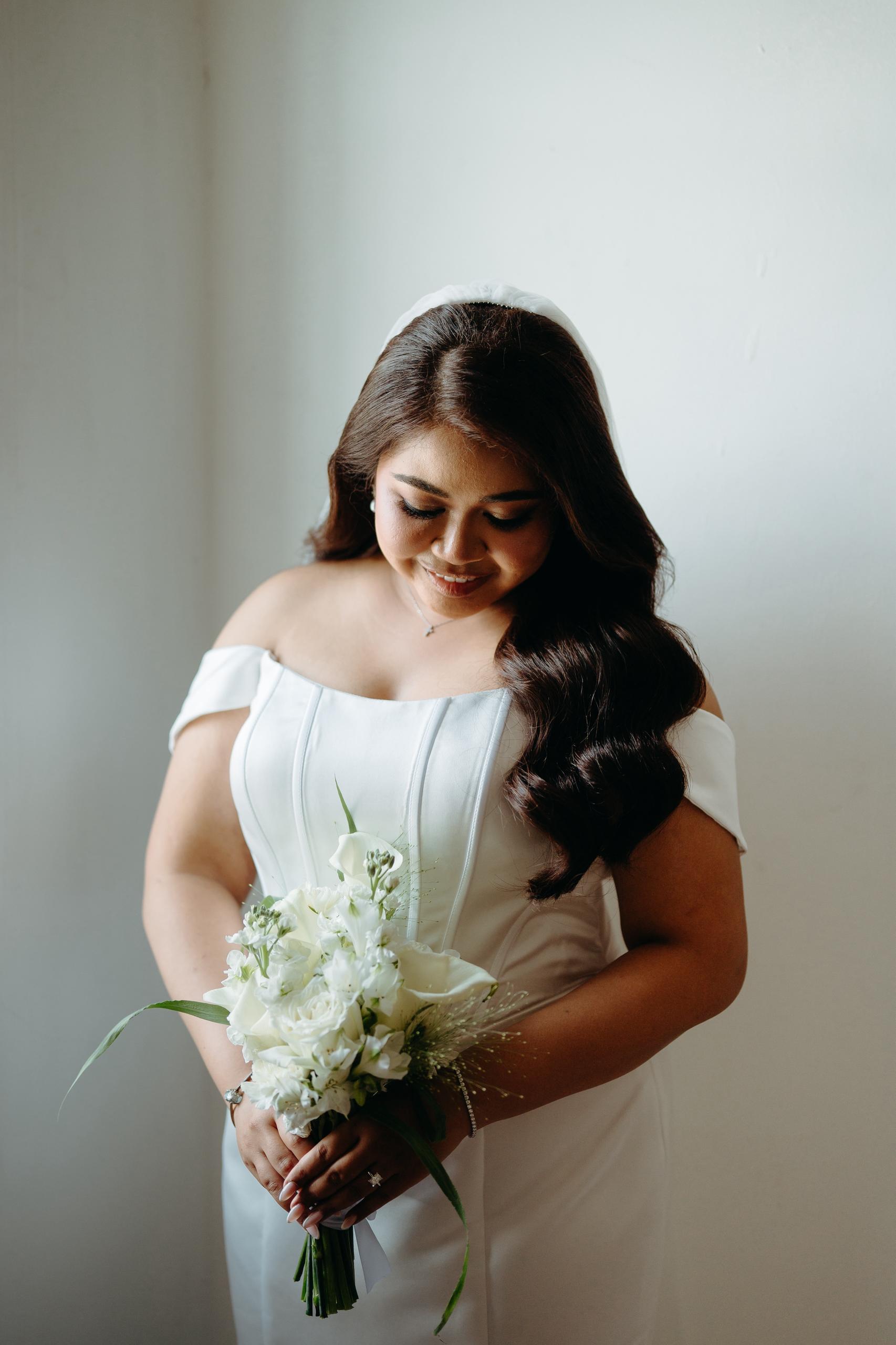 Custom corset wedding gown tailored to Bride Sharon's silhouette by Dentelle Bridal